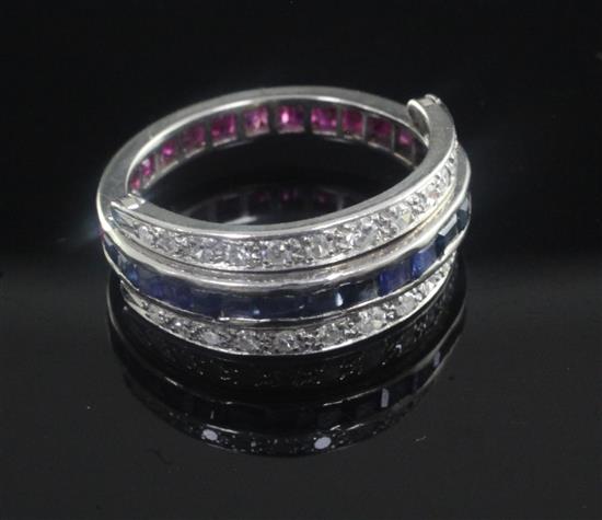 A white gold, ruby, sapphire and diamond set triple band swivel ring, size M.